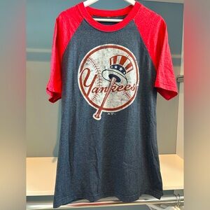 NY Yankees tshirt. Blue/red. Fits men’s large. Weathered logo. Good condition